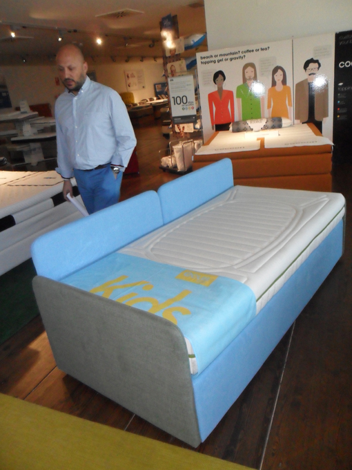 Conrado Padilla, ECUS Managing Director, in the showroom with the Cocoon and the ECUS KIDS mattresses